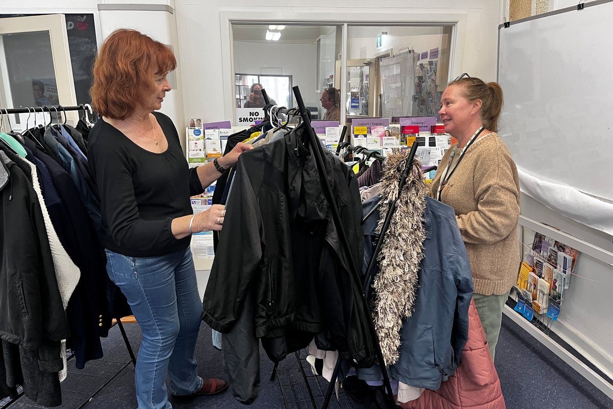 Looking through donated coats on the material aid rack at the Rosebud centre