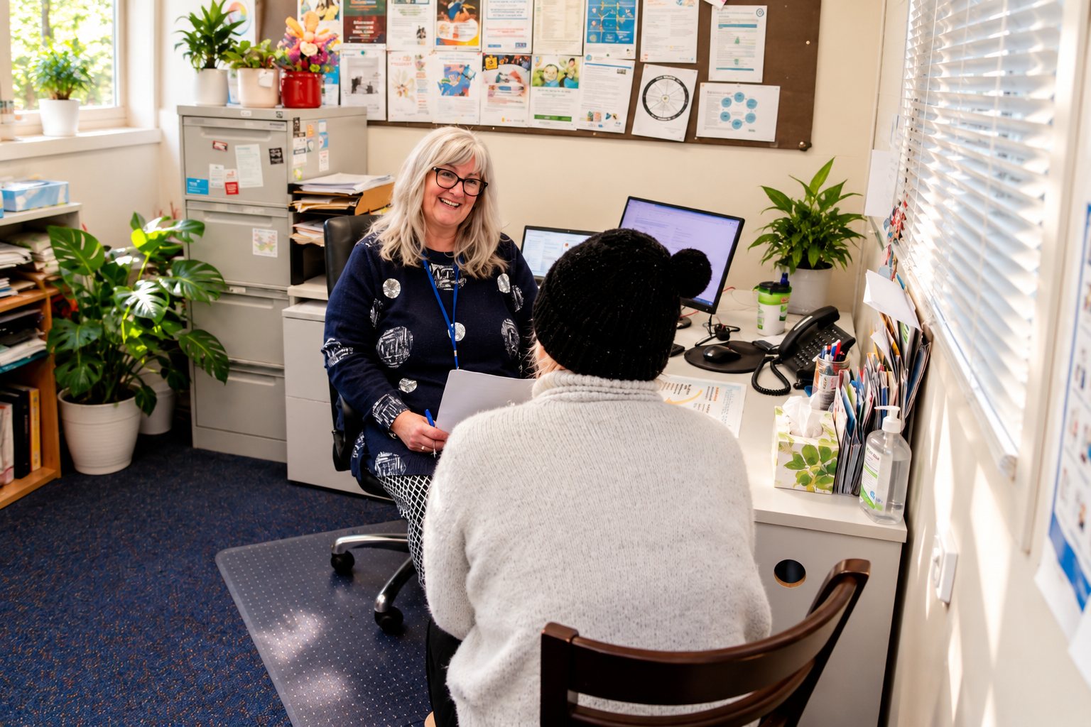 An SPCS family support worker meeting with a client in her office