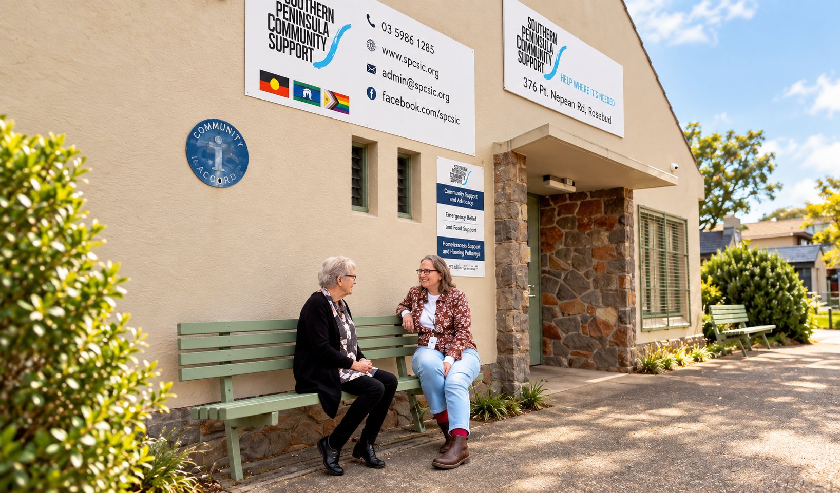 Two people talking on the bench outside the SPCS centre in Rosebud