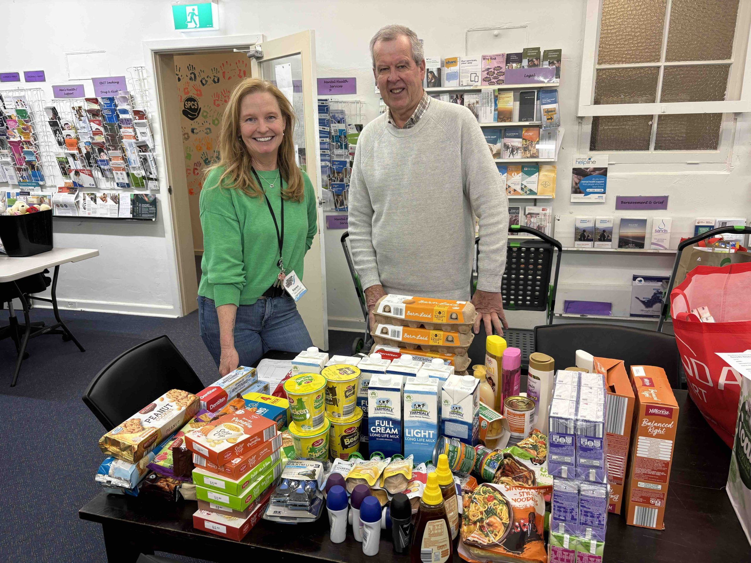 SPCS staff and volunteers with packed hampers of food and essentials