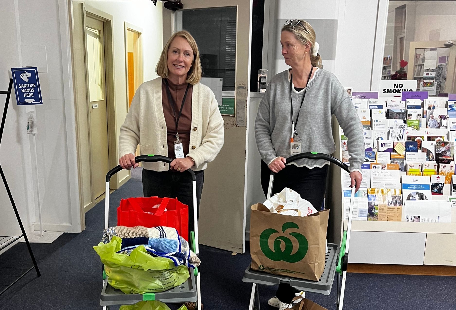 SPCS staff and volunteers with packed hampers of food and essentials