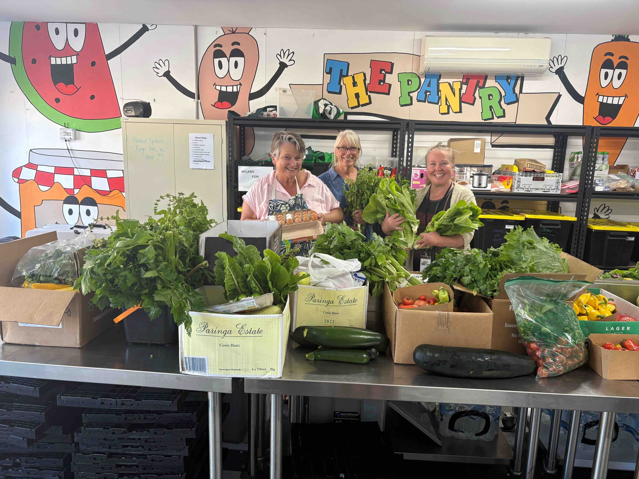 Two SPCS volunteers bagging fresh fruit and vegetables