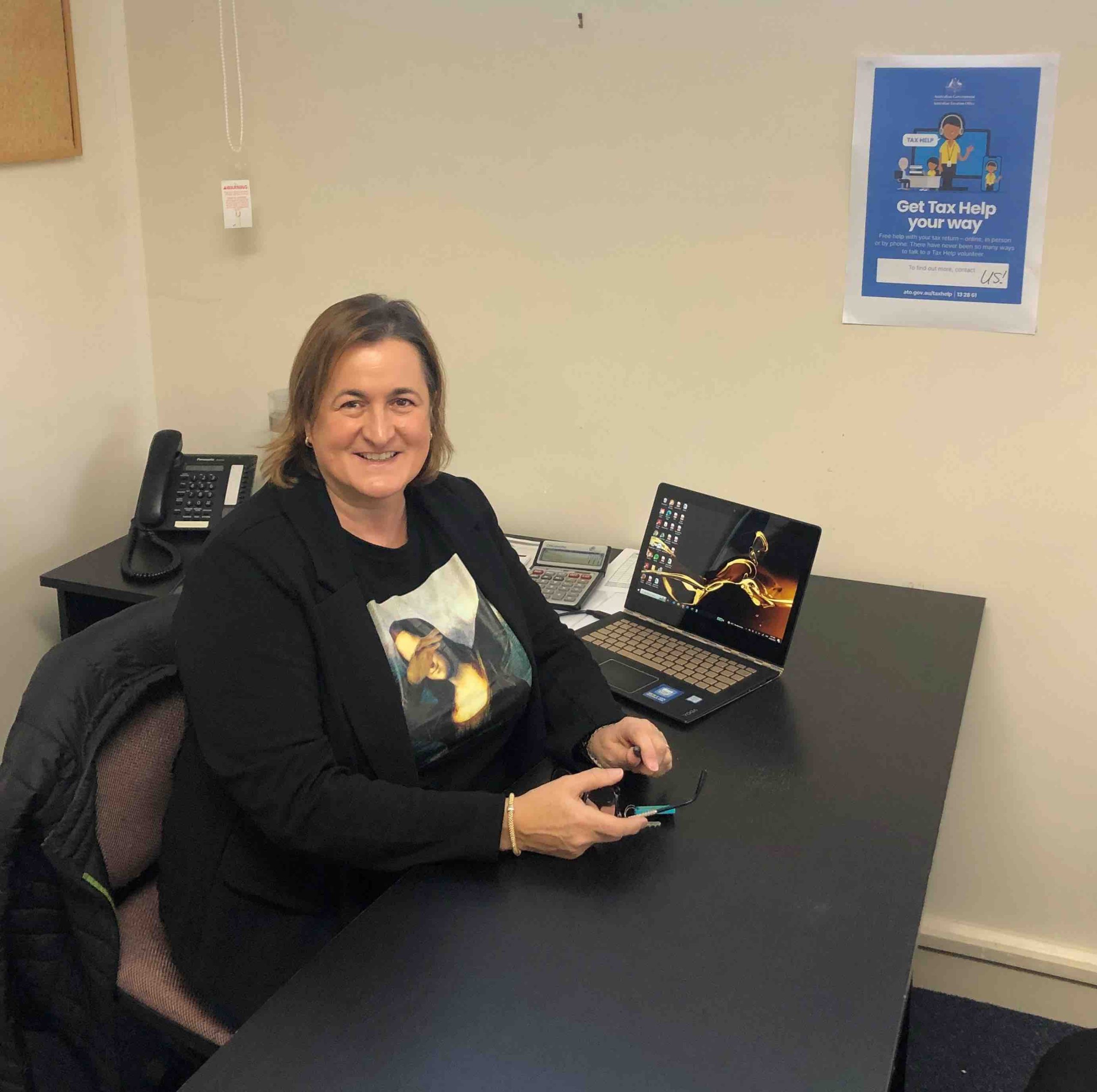 An SPCS support worker going through paperwork with a client